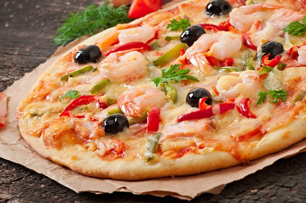 Pizza with shrimp, salmon and olives