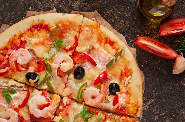 Pizza with shrimp, salmon and olives