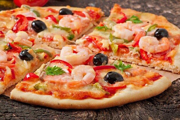 Pizza with shrimp, salmon and olives