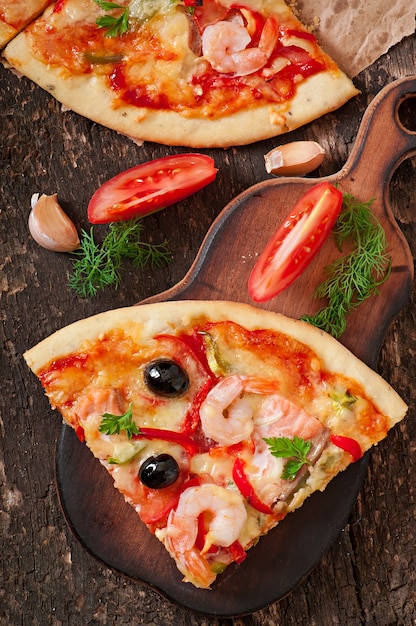 Pizza with shrimp, salmon and olives