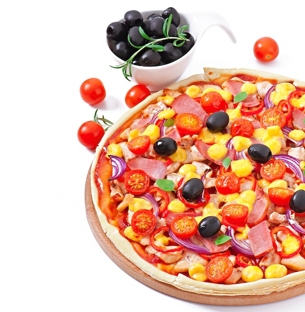 Pizza with vegetables, chicken, ham and olives isolated on white