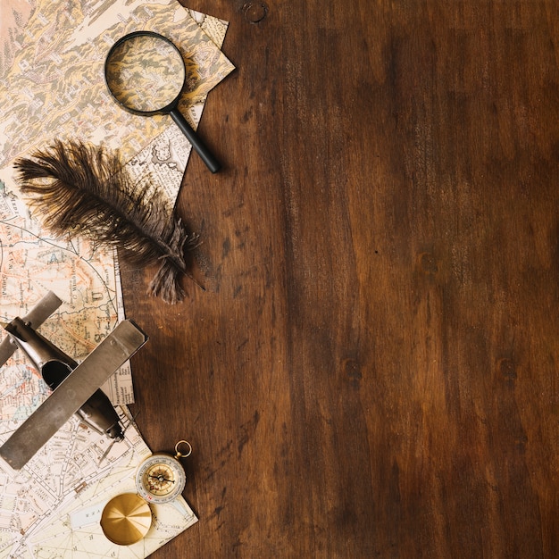 Free Photo plane and feather near tourist stuff on lumber tabletop