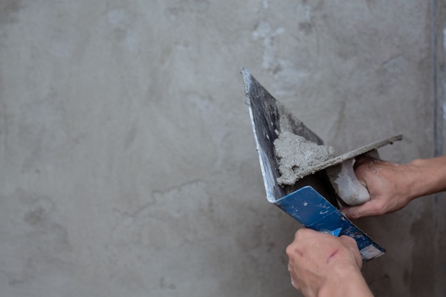 Plasterer renovating indoor walls.