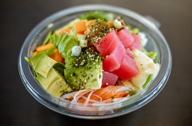 Free photo plastic bowl tasty seafood salad with rice and edamame beans