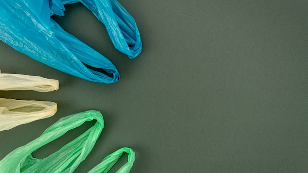 Plastic colorful bags arranged on gray background