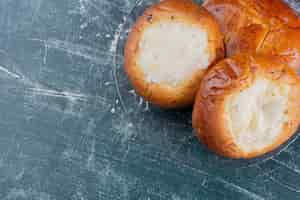 Free photo plate of cheese buns on marble table.