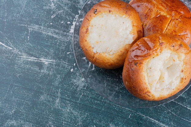 Free Photo plate of cheese buns on marble table.