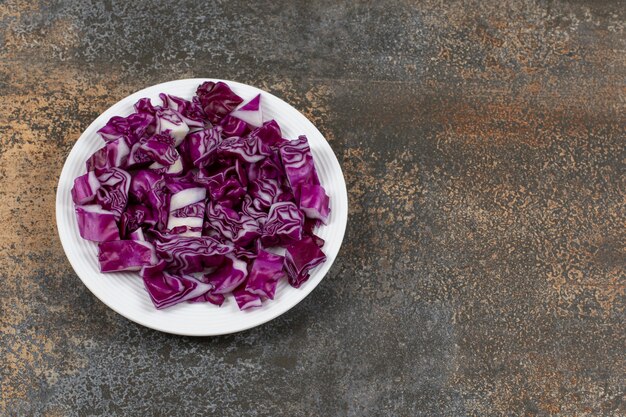 A plate of chopped red cabbage on the marble surface