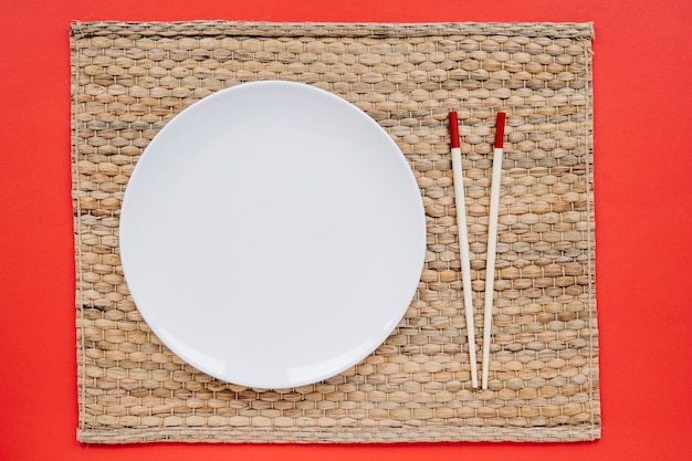 Free photo plate and chopsticks on napkin