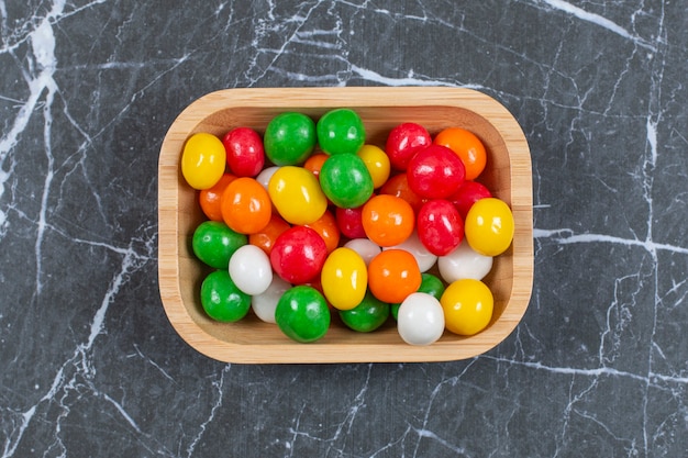 Free photo plate of colorful candies on marble.