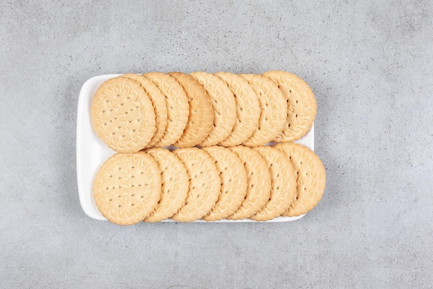 A plate of crispy biscuits on marble background. High quality photo