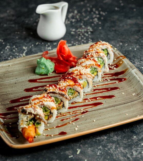 A plate of ebi sushi roll served with wasabi and ginger _