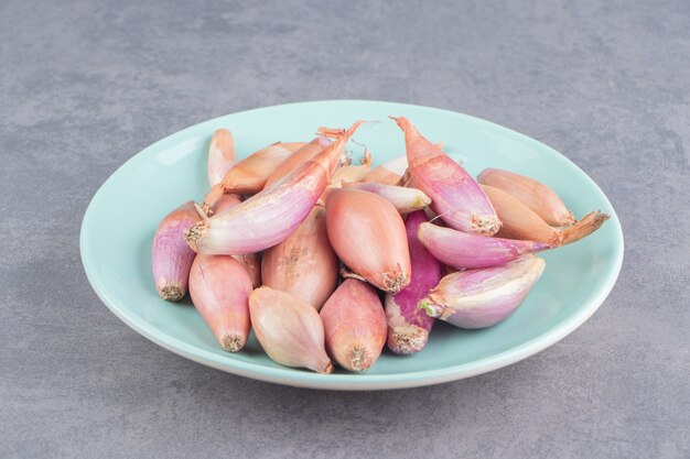 Plate full of onions on the marble surface