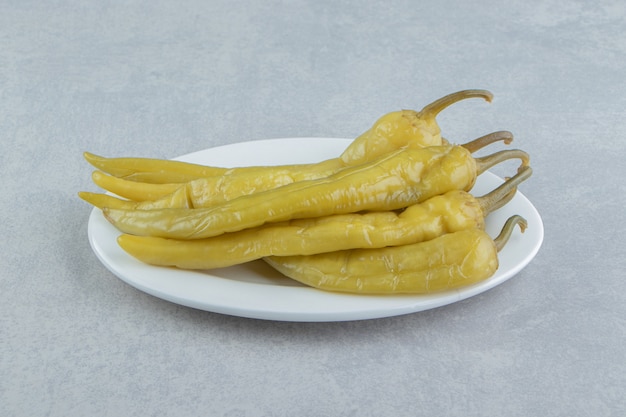 A plate of hot pepper on the marble surface