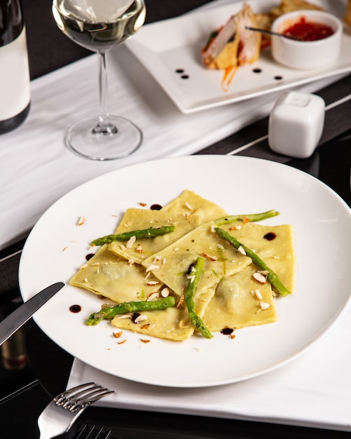 A plate of italian ravioli garnished with asparagus