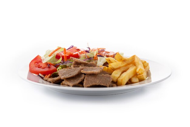 Plate of kebab, vegetables and french fries isolated on white background