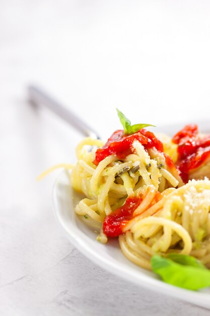 Plate of spaghetti with tomatoes and cheese