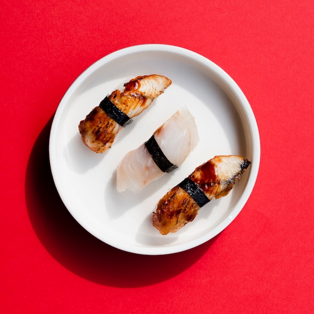 Free Photo plate of sushi on a red background