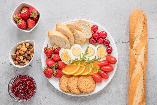 Plate with boiled egg fruits and vegetables for breakfast