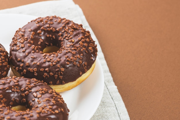 Plate with dark chocolate icing donuts 