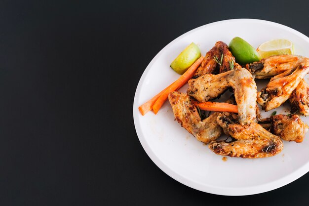 Plate with fried wings and vegetables