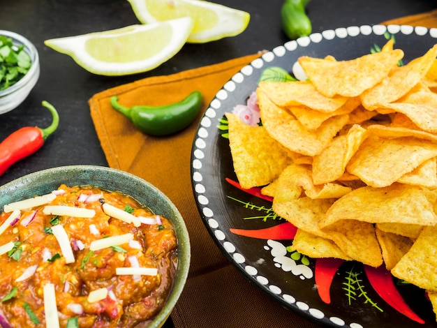 Plate with tacos near cup of garnish and vegetables