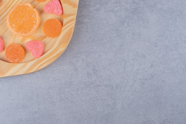 Platter of delicious marmelades on marble surface