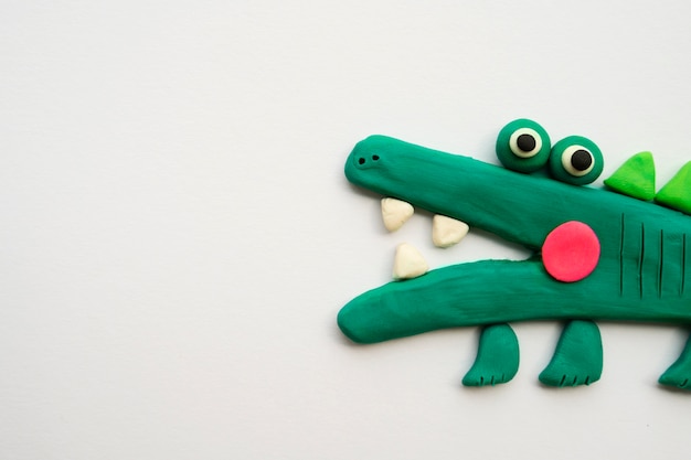 Free photo play dough background with alligator  top view