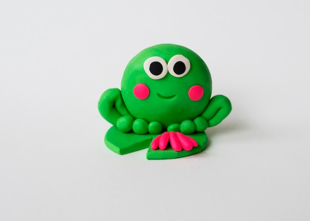 Play dough background with cute frog