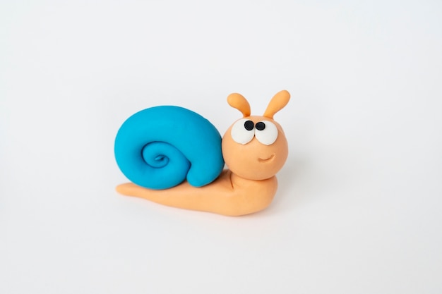 Play dough background with snail high angle