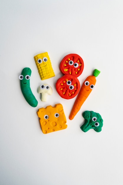 Free photo play dough background with vegetables above view