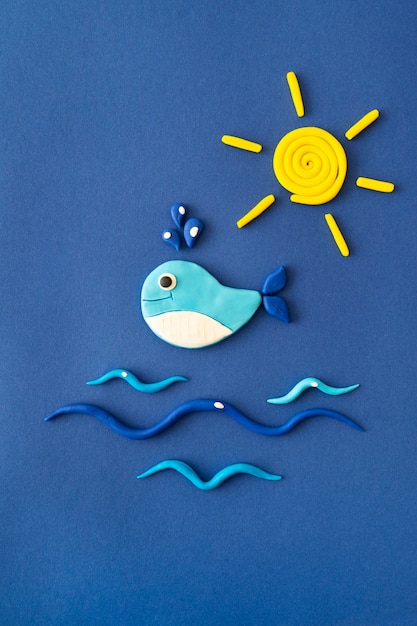 Play dough background with whale and sun