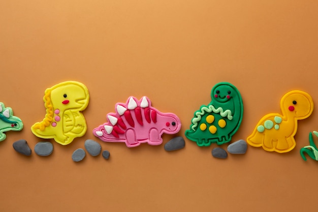 Free photo playdough art with dinosaurus flat lay