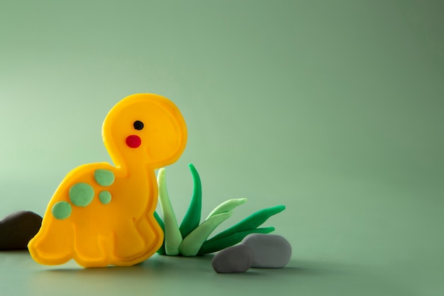 Free photo playdough art with yellow dinosaur