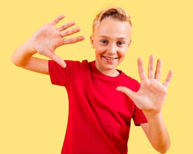 Playful boy showing both hands in free mood