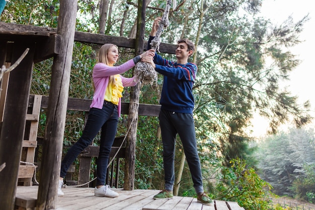 Free photo playful couple trying to pull the rope