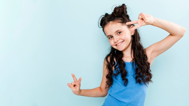 Playful girl showing peace sign