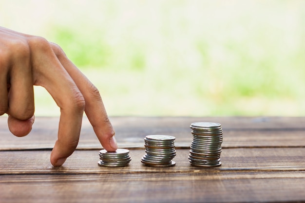 Playful hand with savings coin