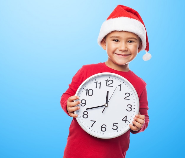 Playful kid with a clock