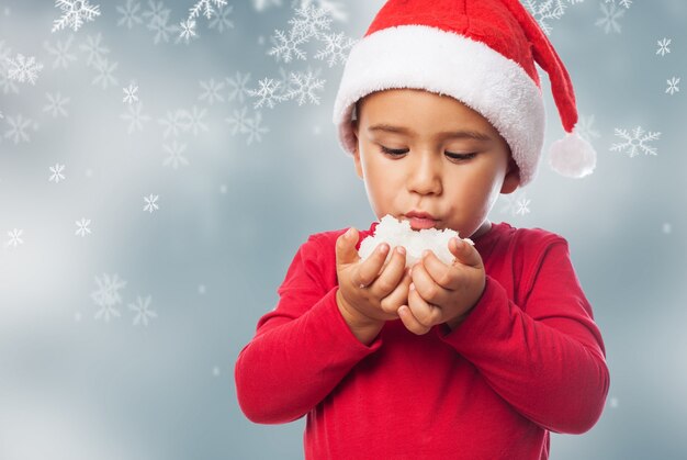 Playful kid with snow on his hand palms