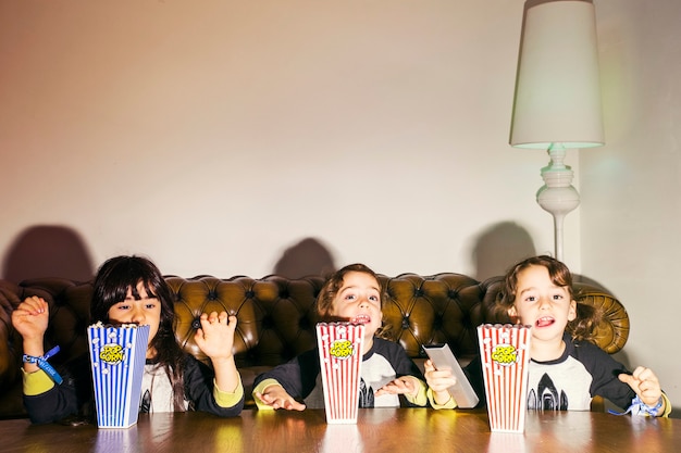 Playful little girls with popcorn in dark