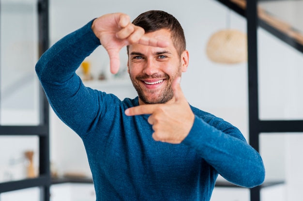 Free photo playful man smiling for camera