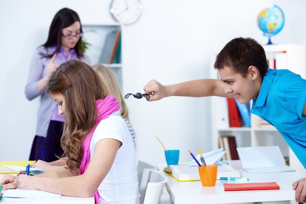 Playful student with a plastic spider