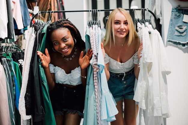 Playful women in clothing store