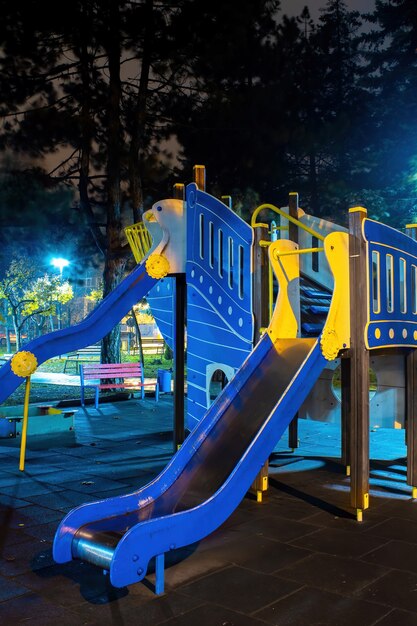 Playground in a park at night.