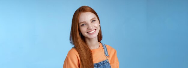 Pleasant sincere happy ginger girl blue eyes tilting head grinning happily laughing stay positive