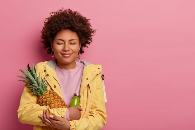 Free photo pleased curly afro american woman has healthy nutrition