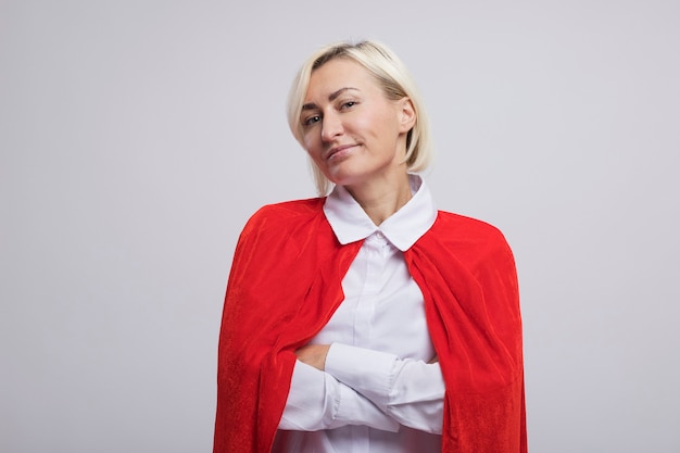 Free Photo pleased middle-aged blonde superhero woman in red cape 