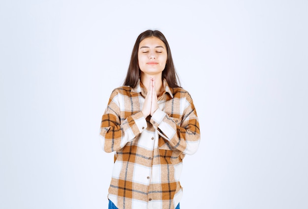 Free photo pleased young girl model praying peacefully.