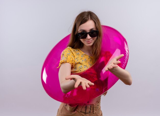 Free Photo pleased young girl wearing sunglasses and swim ring showing empty hands on isolated white space with copy space